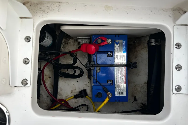 Slide: The Image of 2018 Robalo R180 Center Console boat battery compartment with wiring and connections. - 29