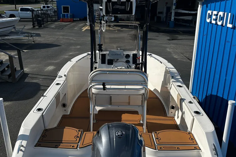 Slide: The Image of 2018 Robalo R180 Center Console boat at a marina, featuring a Garmin navigation system. - 9