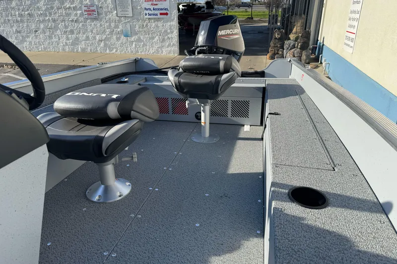 Slide: The Image of 2026 Lund 1400 Fury SS boat interior with seating and Mercury engine. - 10