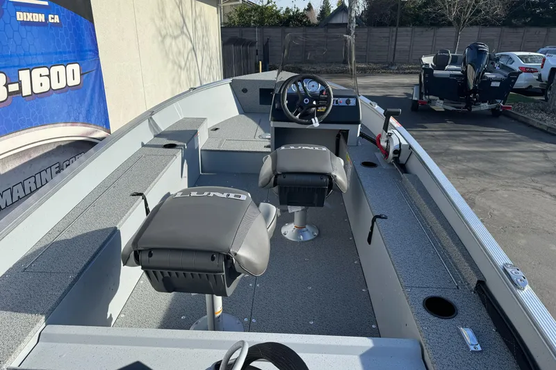 Slide: The Image of 2026 Lund 1400 Fury SS boat interior with steering wheel and seating. - 6