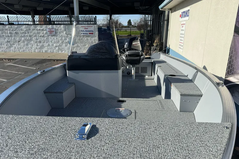 Slide: The Image of 2026 Lund 1400 Fury SS fishing boat interior with seating and storage compartments. - 9