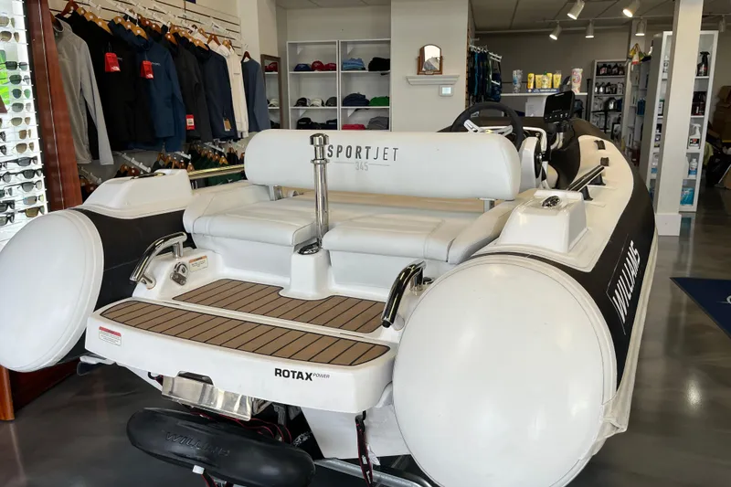 Slide: The Image of 2023 Williams Jet Tenders Sportjet 345 displayed in a showroom with clothing and accessories. - 4