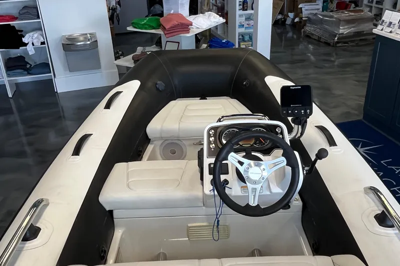 Slide: The Image of 2023 Williams Jet Tenders Sportjet 345 interior with steering wheel and controls. - 5