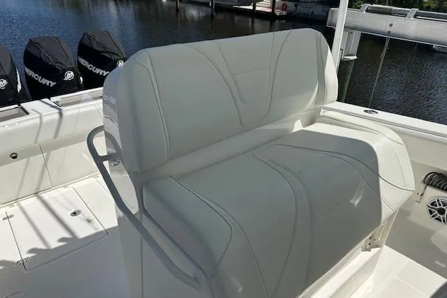 Slide: The Image of 2024 SeaVee 340Z boat with white seating and Mercury engines in the background. - 13
