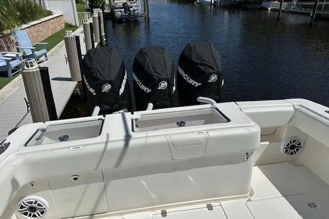 Slide: The Image of 2024 SeaVee 340Z boat with triple Mercury engines docked by the water. - 16