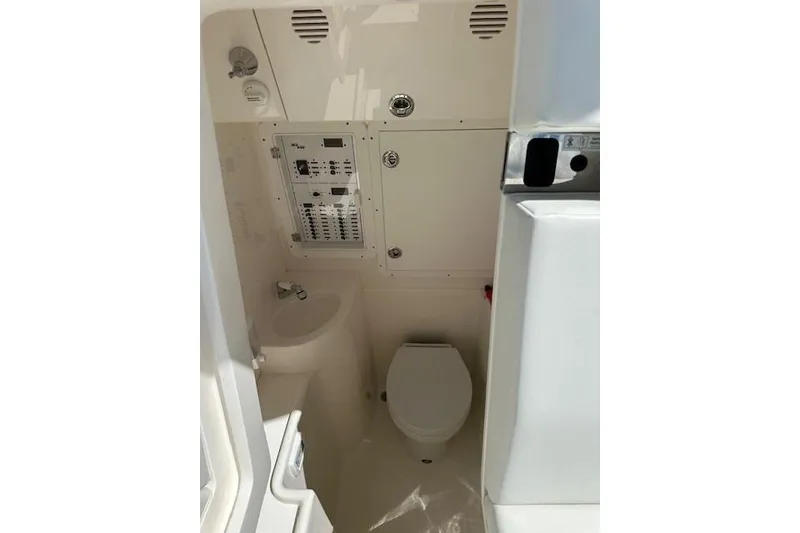 Slide: The Image of 2024 SeaVee 340Z boat interior with compact bathroom and control panel. - 17