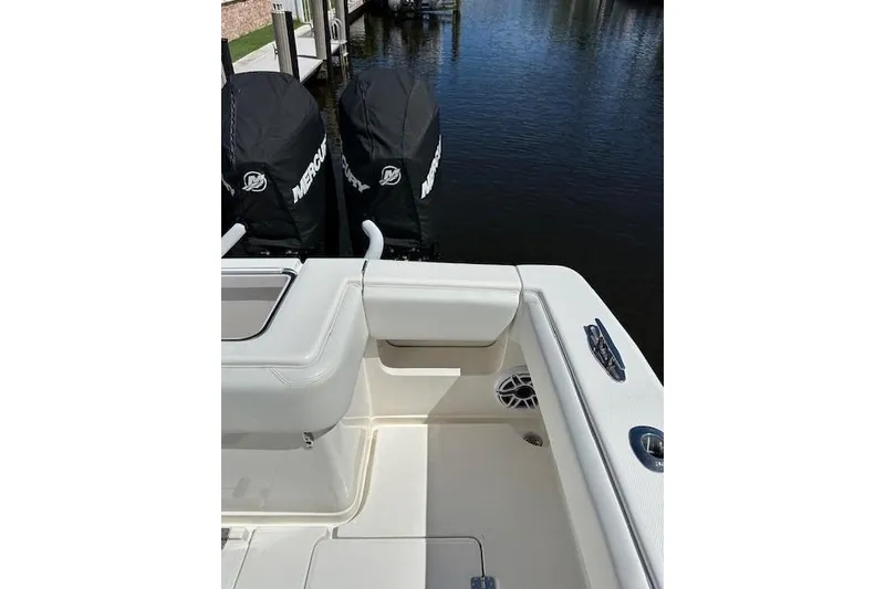 Slide: The Image of 2024 SeaVee 340Z boat with dual Mercury engines, docked by the water. - 18