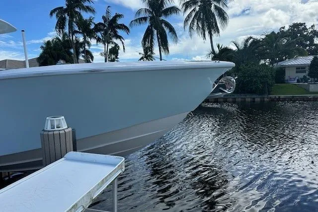 Slide: The Image of 2024 SeaVee 340Z boat docked by a scenic waterfront with palm trees. - 5