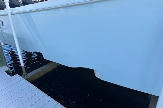 Slide: The Image of 2024 SeaVee 340Z boat hull docked, showcasing sleek design and smooth finish. - 6