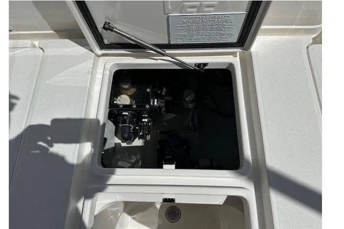 Slide: The Image of 2024 SeaVee 340Z boat compartment with open hatch, showcasing internal components. - 9