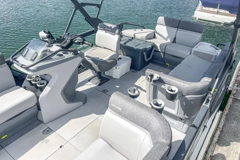 Slide: The Image of 2023 Sea-Doo Switch Cruise 21 interior with seating and steering console on water. - 16