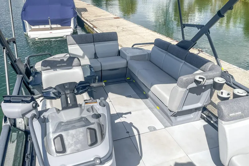 Slide: The Image of 2023 Sea-Doo Switch Cruise 21 pontoon boat interior with spacious seating and modern design. - 17
