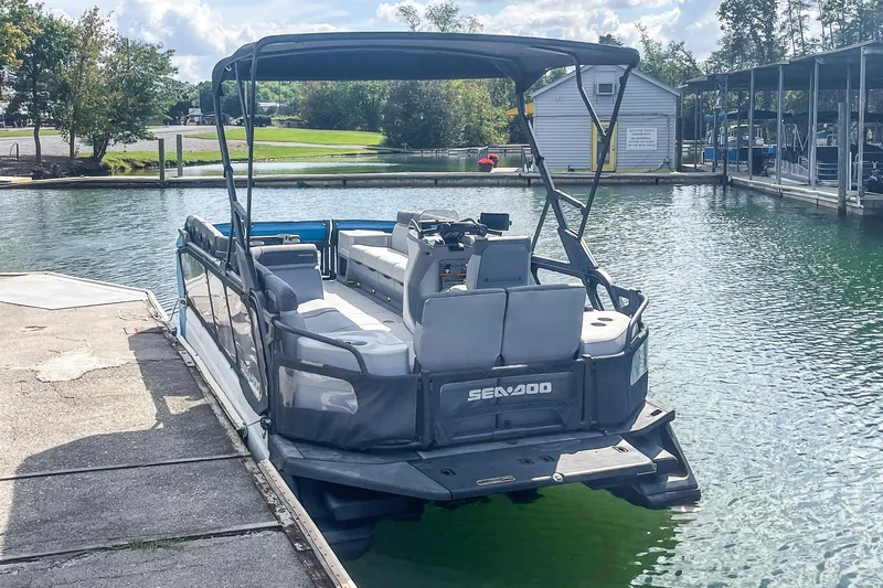 Slide: The Image of 2023 Sea-Doo Switch Cruise 21 docked at a marina, showcasing spacious seating. - 2