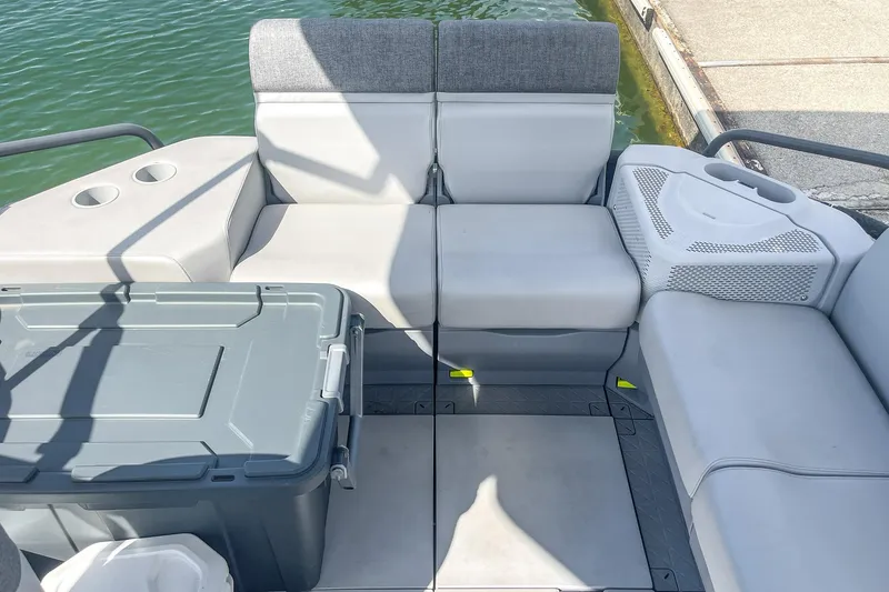 Slide: The Image of 2023 Sea-Doo Switch Cruise 21 interior with gray seating and storage box. - 20