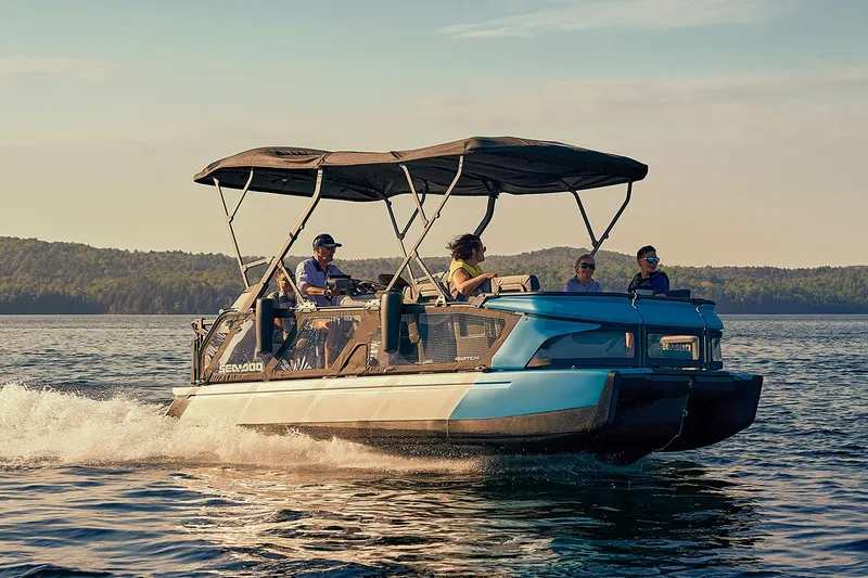 Slide: The Image of Manufacturer Provided Image: 2023 Sea-Doo Switch Cruise 21 pontoon boat cruising on a lake with passengers. - 24