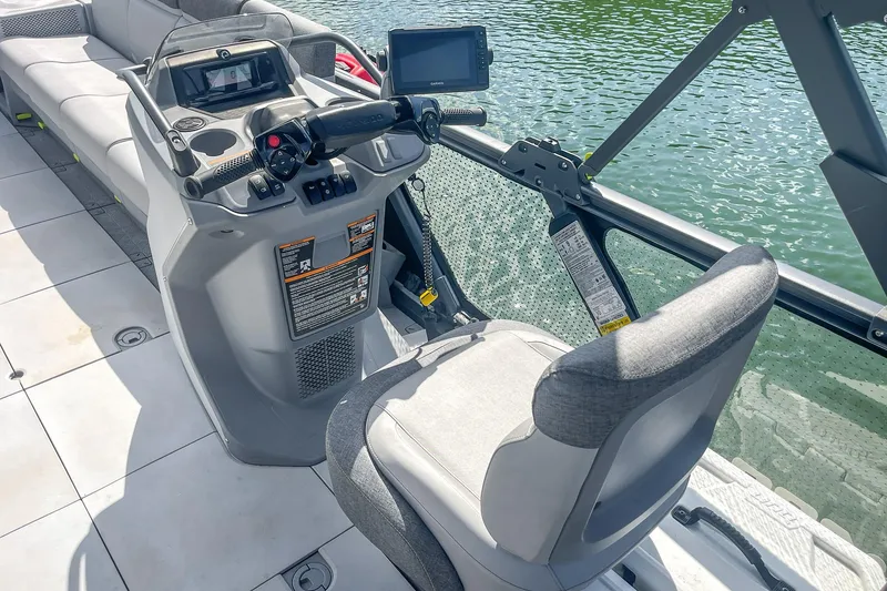 Slide: The Image of 2023 Sea-Doo Switch Cruise 21 helm with modern controls and seating on water. - 6