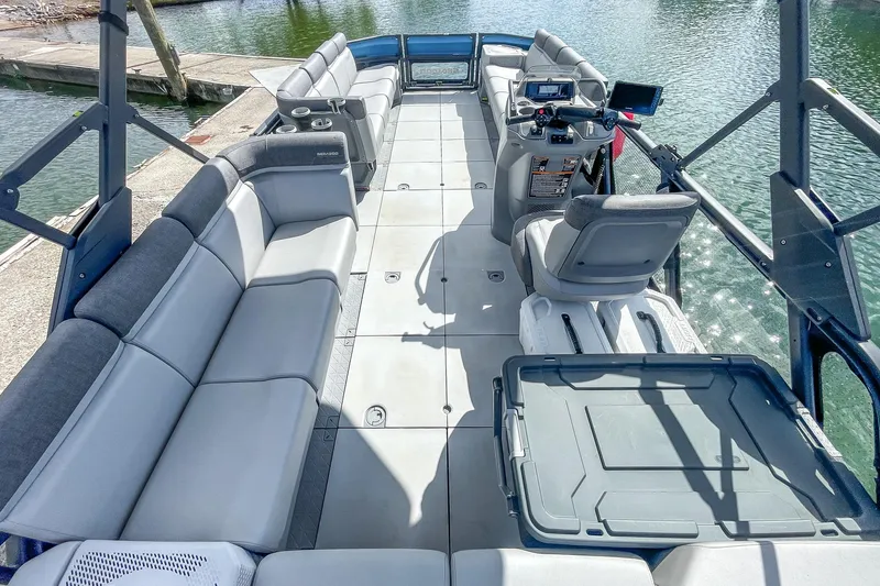 Slide: The Image of 2023 Sea-Doo Switch Cruise 21 pontoon boat interior with spacious seating and modern controls. - 9