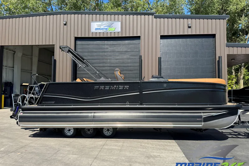 The Image of 2026 Premier 230 Solaris RL pontoon boat parked outside a marine facility. - 0