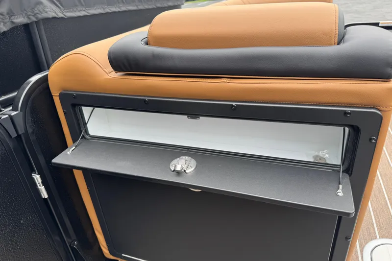 Slide: The Image of 2026 Premier 230 Solaris RL boat interior with tan and black seating and storage compartment. - 11