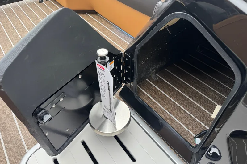 Slide: The Image of Open storage compartment on 2026 Premier 230 Solaris RL boat with striped flooring. - 14