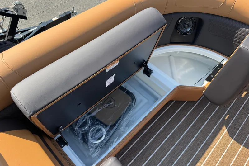 Slide: The Image of 2026 Premier 230 Solaris RL boat interior with open storage compartment and speaker. - 21