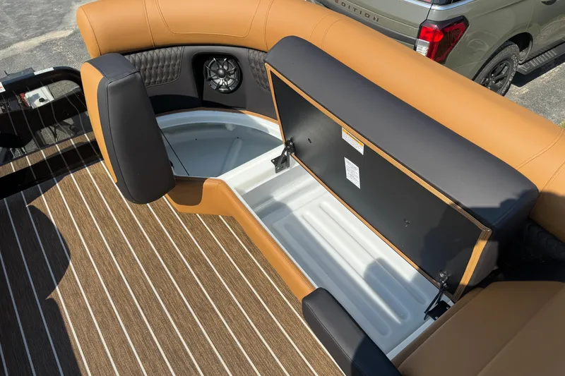 Slide: The Image of 2026 Premier 230 Solaris RL boat interior with open storage compartment and stylish seating. - 22