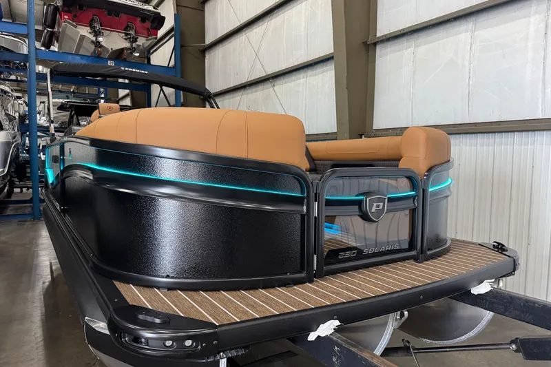 Slide: The Image of 2026 Premier 230 Solaris RL pontoon boat with sleek design and ambient lighting. - 23