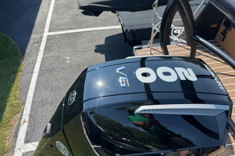 Slide: The Image of Outboard motor on 2026 Premier 230 Solaris RL boat, parked on asphalt. - 27