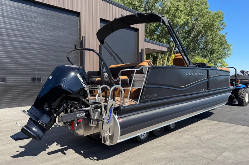Slide: The Image of 2026 Premier 230 Solaris RL pontoon boat with Mercury outboard engine, docked outdoors. - 3