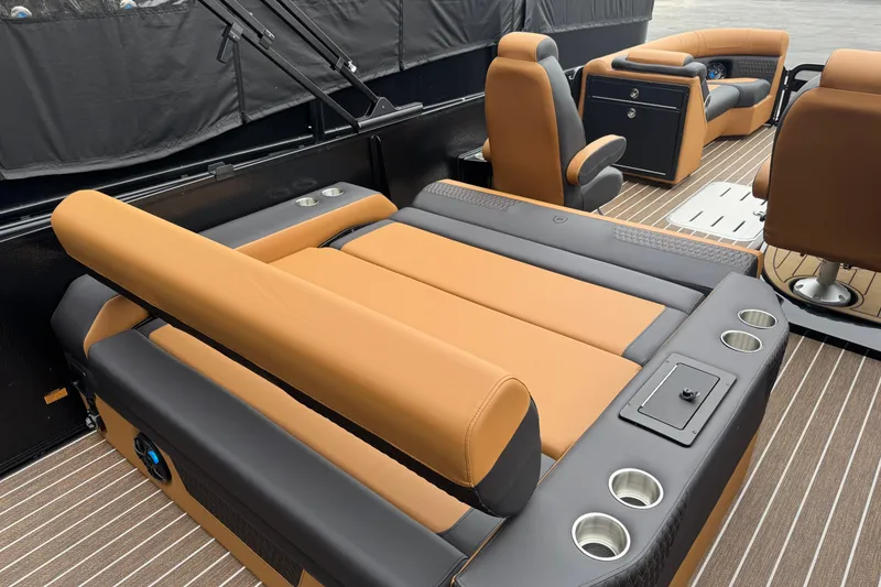 Slide: The Image of Luxurious interior of 2026 Premier 230 Solaris RL pontoon boat with plush seating and cup holders. - 31