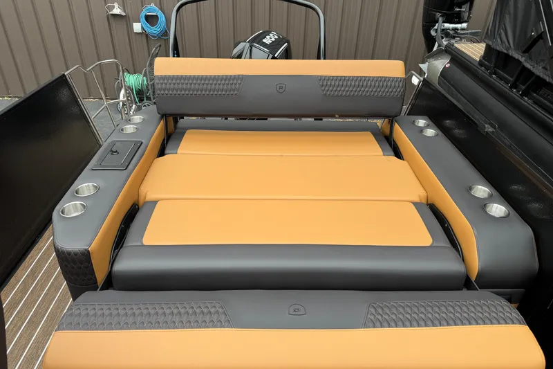 Slide: The Image of 2026 Premier 230 Solaris RL boat interior with tan and gray seating, cup holders, and sleek design. - 32