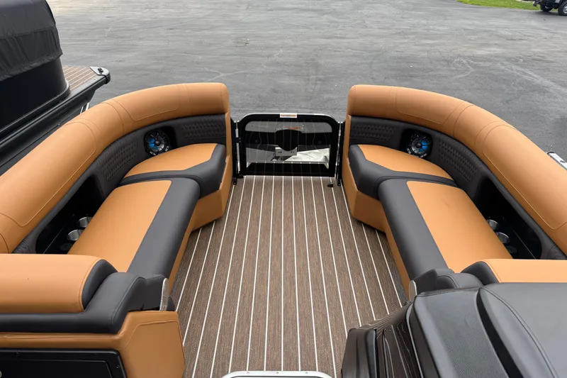 Slide: The Image of 2026 Premier 230 Solaris RL boat interior with tan and black seating, striped flooring. - 35