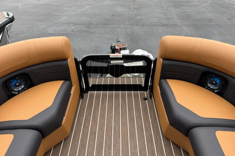 Slide: The Image of 2026 Premier 230 Solaris RL boat interior with tan and black seating, striped flooring. - 36