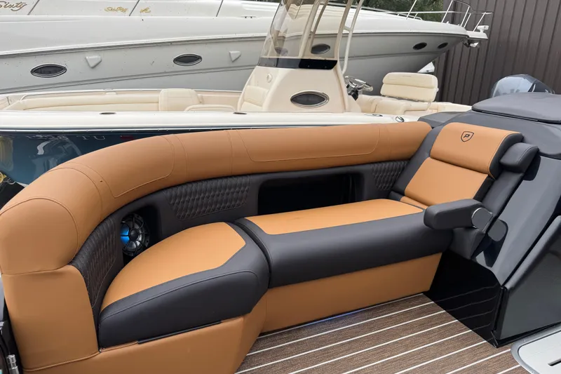 Slide: The Image of Luxurious seating on 2026 Premier 230 Solaris RL boat, featuring tan and black upholstery. - 37