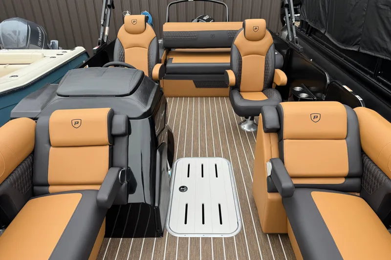 Slide: The Image of Luxurious interior of 2026 Premier 230 Solaris RL pontoon boat with tan and black seating. - 39