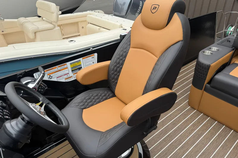 Slide: The Image of Luxurious 2026 Premier 230 Solaris RL boat interior with tan and black captain's chair. - 42