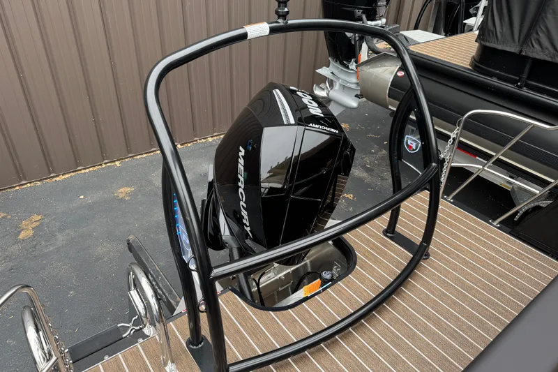 Slide: The Image of 2026 Premier 230 Solaris RL boat with Mercury outboard motor, docked on striped deck. - 7