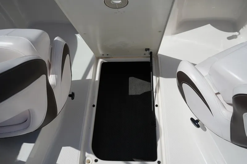Slide: The Image of 2020 Chaparral 23 SSi OB boat interior with open storage compartment and seating. - 15