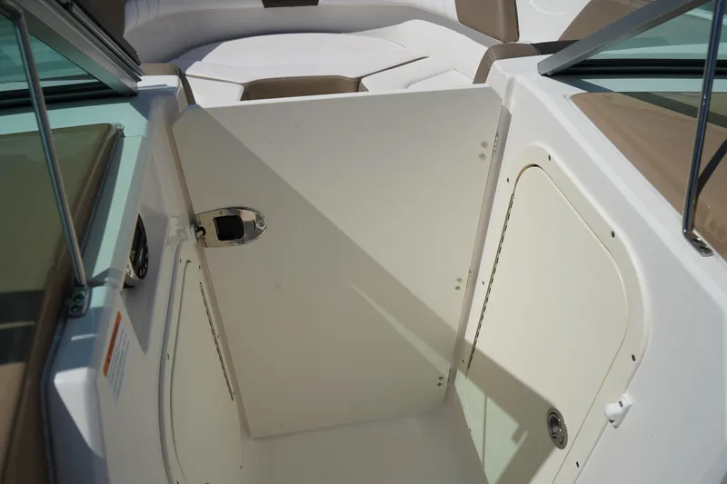 Slide: The Image of 2020 Chaparral 23 SSi OB boat interior with open storage compartment. - 16
