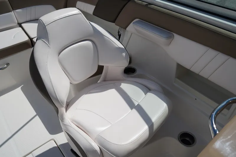 Slide: The Image of 2020 Chaparral 23 SSi OB boat interior with white cushioned seating. - 18