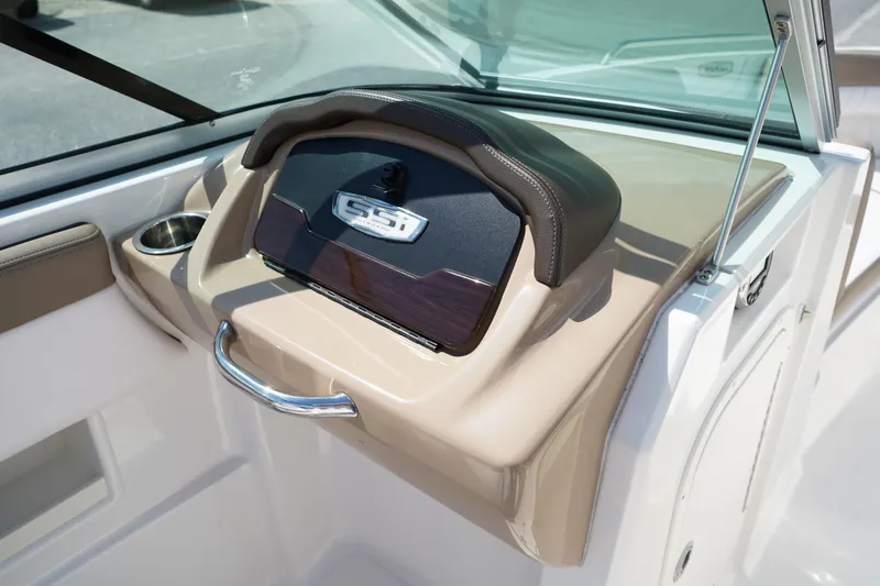 Slide: The Image of 2020 Chaparral 23 SSi OB boat dashboard with cup holder and sleek design. - 20