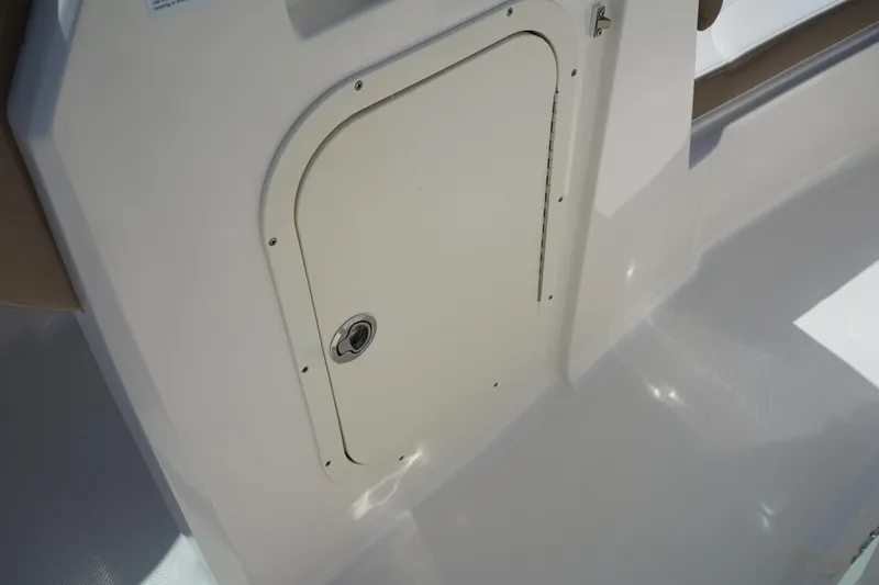 Slide: The Image of 2020 Chaparral 23 SSi OB boat storage compartment with secure latch. - 21