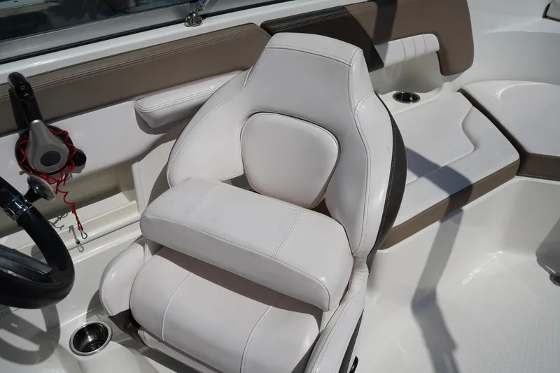 Slide: The Image of 2020 Chaparral 23 SSi OB boat interior with white seating and steering wheel. - 23
