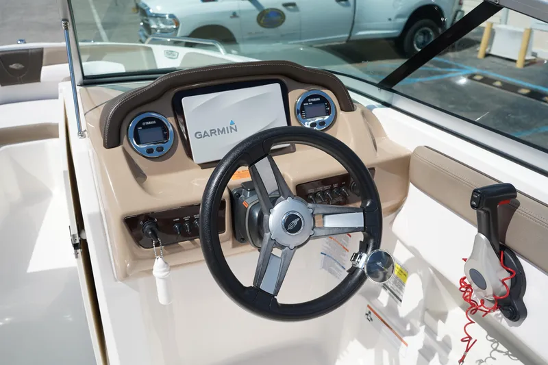 Slide: The Image of 2020 Chaparral 23 SSi OB boat dashboard with Garmin display and steering wheel. - 25