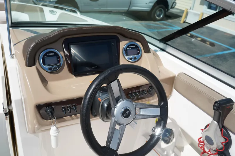 Slide: The Image of 2020 Chaparral 23 SSi OB boat dashboard with steering wheel and control panel. - 26