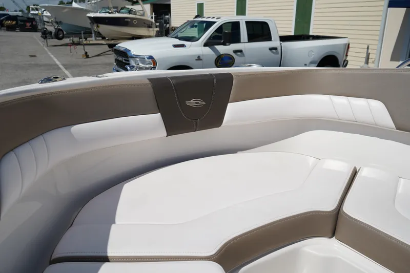 Slide: The Image of 2020 Chaparral 23 SSi OB boat interior with white and beige seating. - 37
