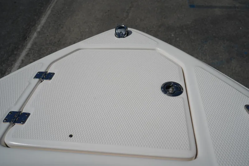 Slide: The Image of Bow storage compartment on 2020 Chaparral 23 SSi OB boat, featuring textured surface. - 41