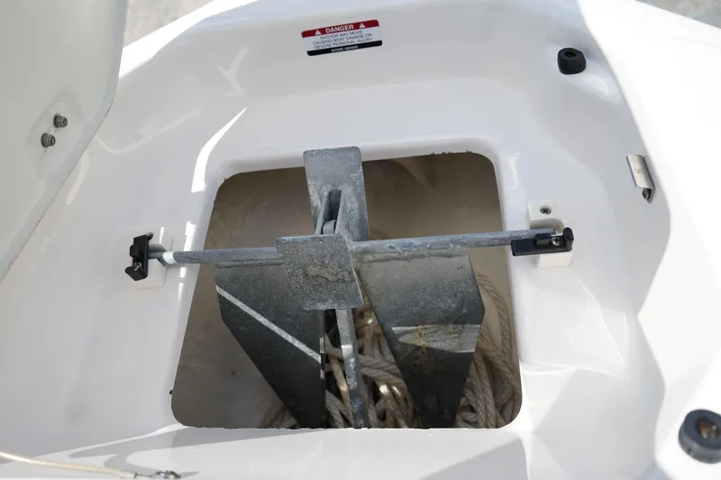 Slide: The Image of Anchor compartment of 2020 Chaparral 23 SSi OB boat with secured anchor and rope. - 42