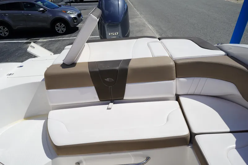 Slide: The Image of 2020 Chaparral 23 SSi OB boat interior with cushioned seating and Yamaha 150 outboard motor. - 7