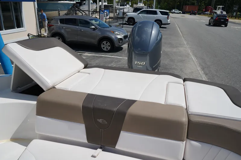 Slide: The Image of 2020 Chaparral 23 SSi OB boat with Yamaha 150 engine, parked near vehicles. - 8
